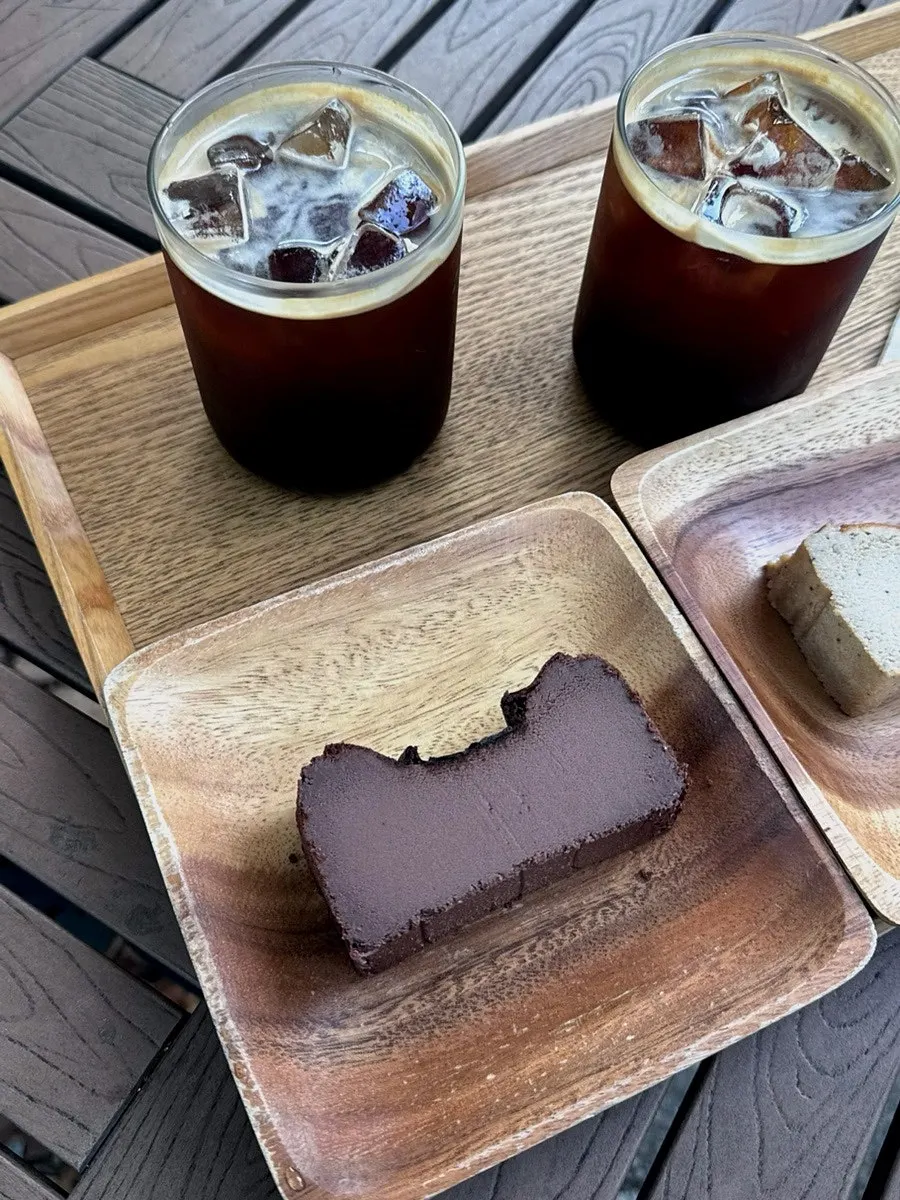 Dessert set at an outdoor table with green trees in the background