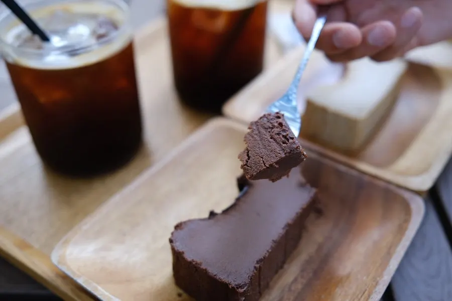 Cross-section of chocolate Basque cheesecake cut with a fork