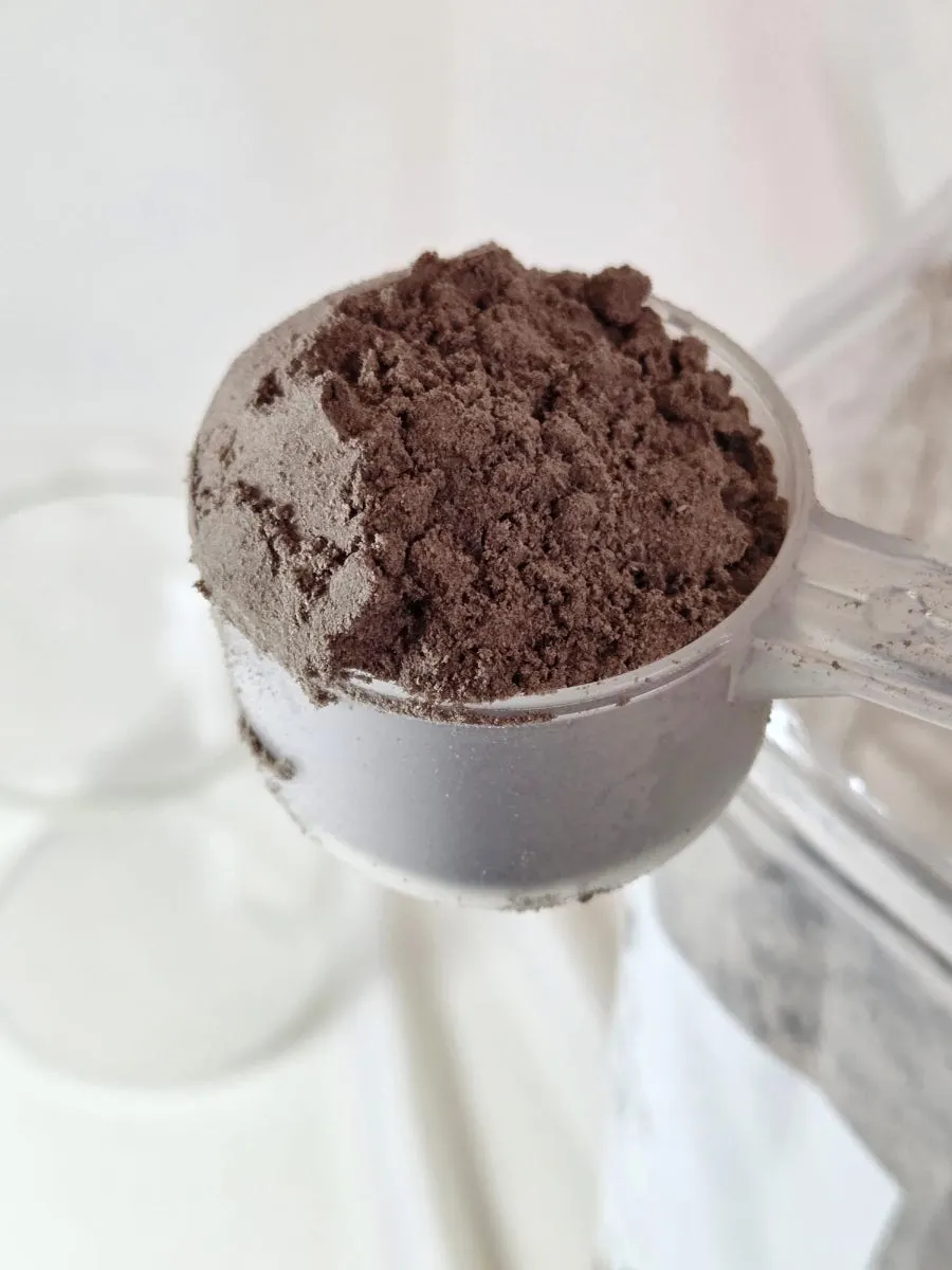 Two scoops of choco soy milk powder in a cup