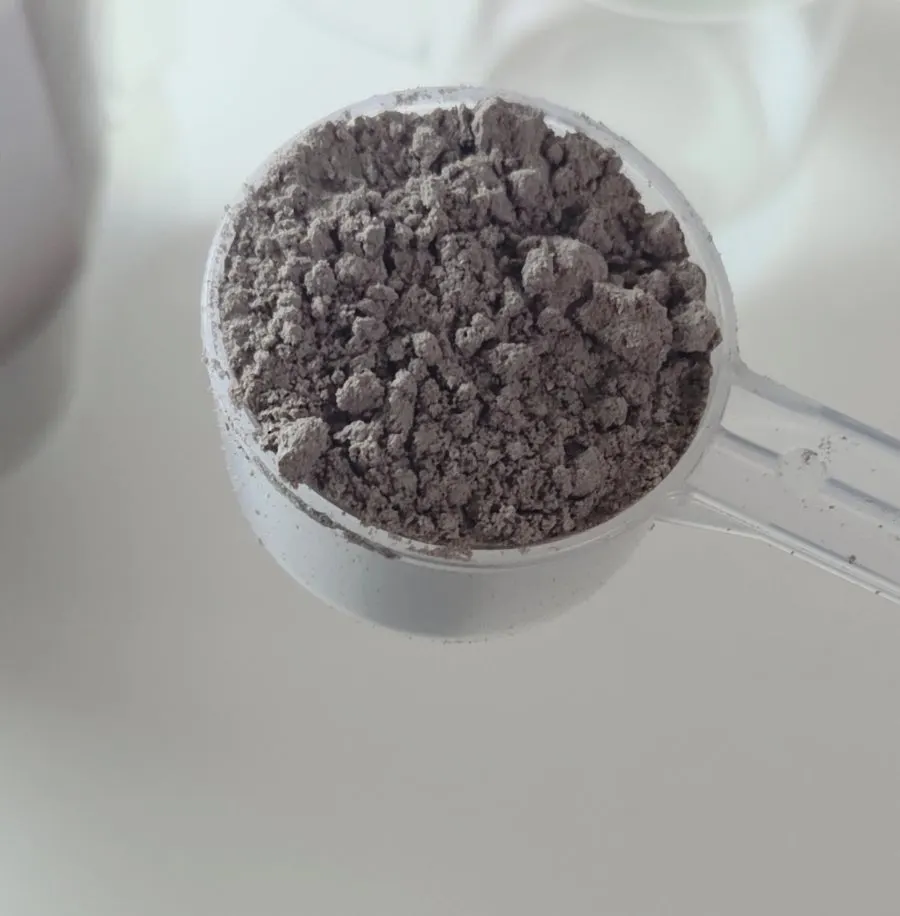 Making a cup of choco soy milk by pouring water into the powder