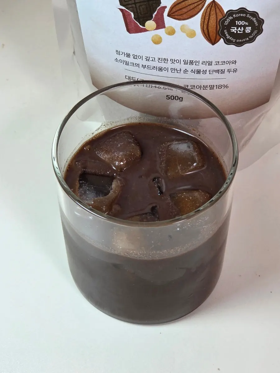 Cup of choco soy milk powder after water is poured in