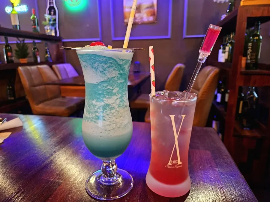 Two glasses: X-ray T highball and Blue Hawaiian