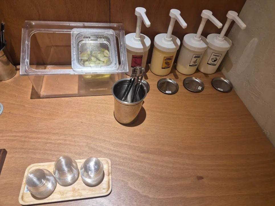 Self-serve bar with wet wipes, knives, and forks