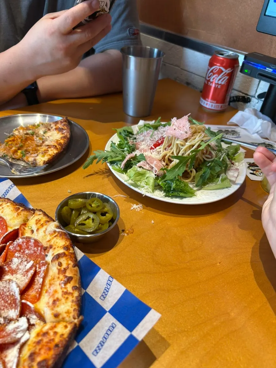 Pizza and salad already set on the table