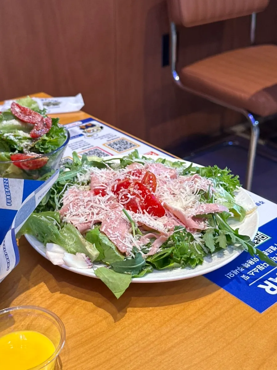Table set with both salad and pizza