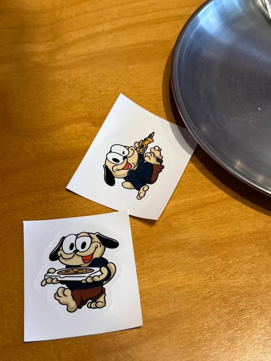 Pug Pizza House sticker stuck on a phone