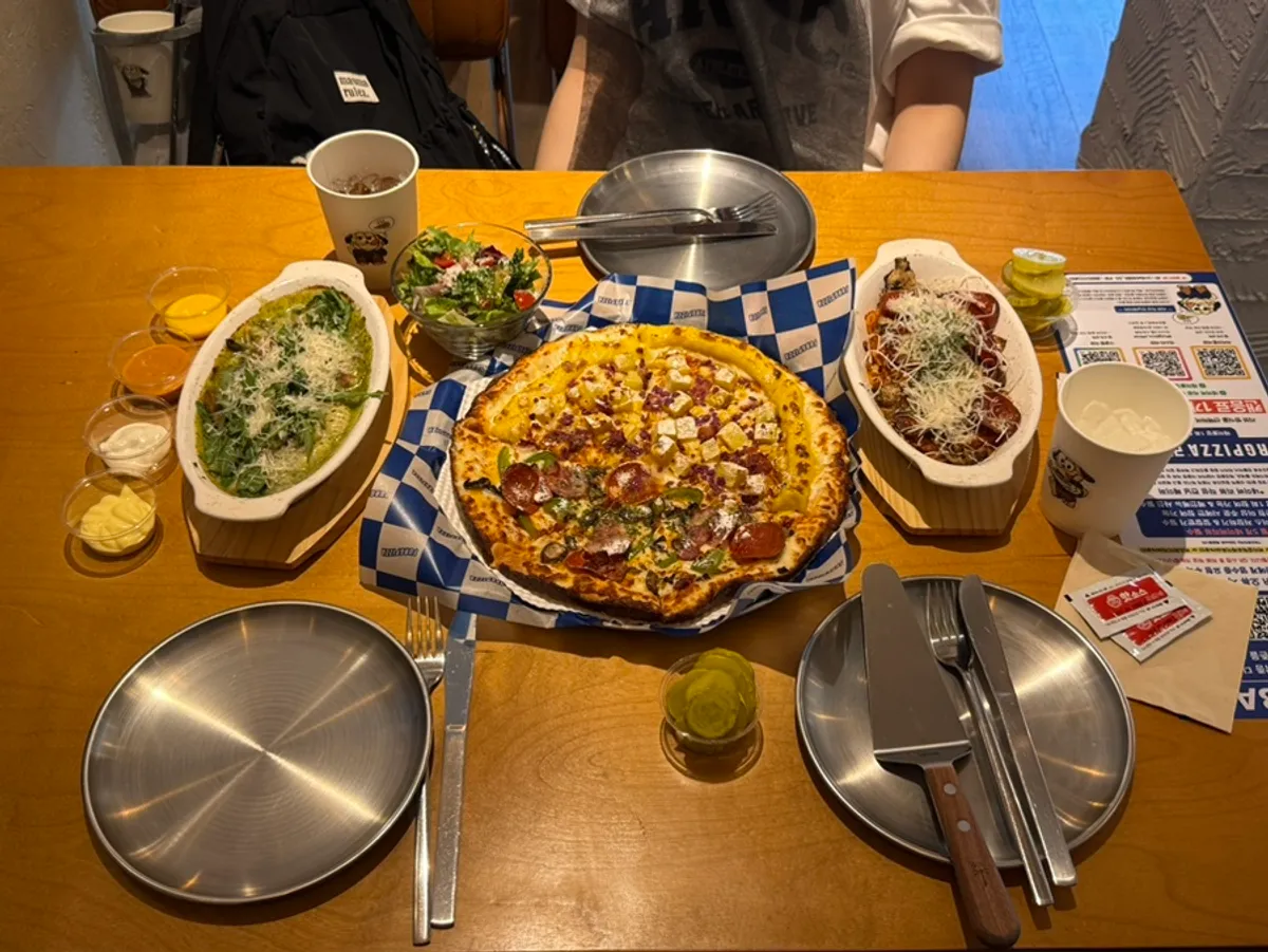 Table spread with half-and-half pizza, pasta, and gnocchi from the Signature Value Set