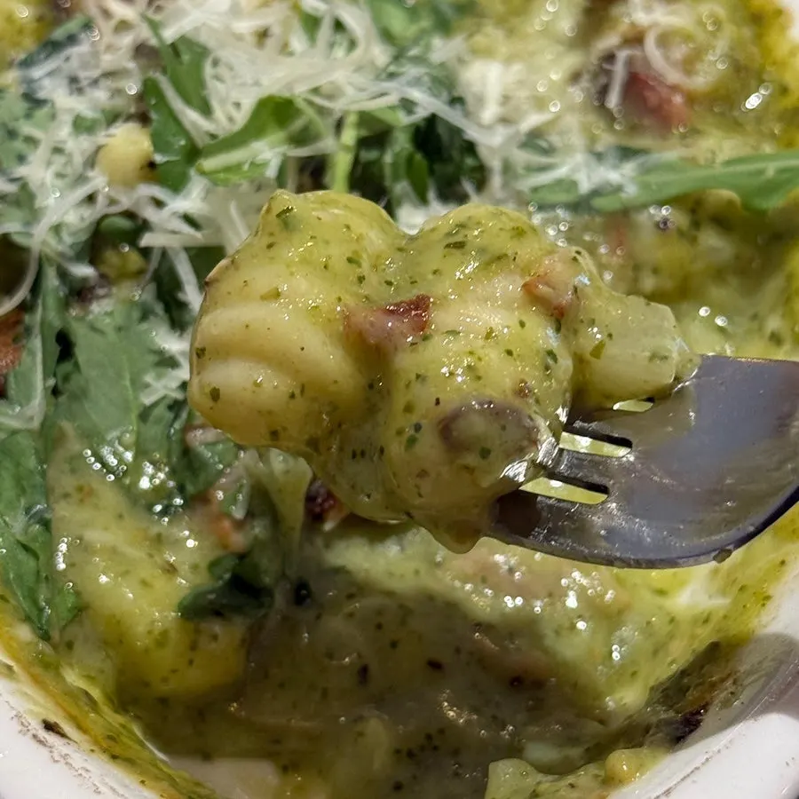 Basil cream tteok-gnocchi topped with arugula and cheese