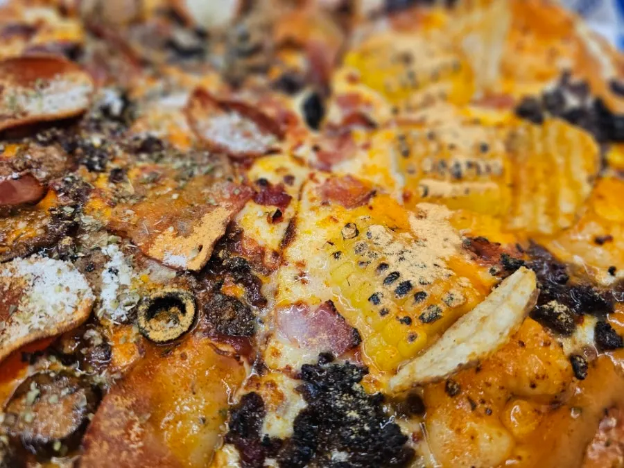 Freshly made Mad Max American and Amazing Shrimp XR half-and-half pizza