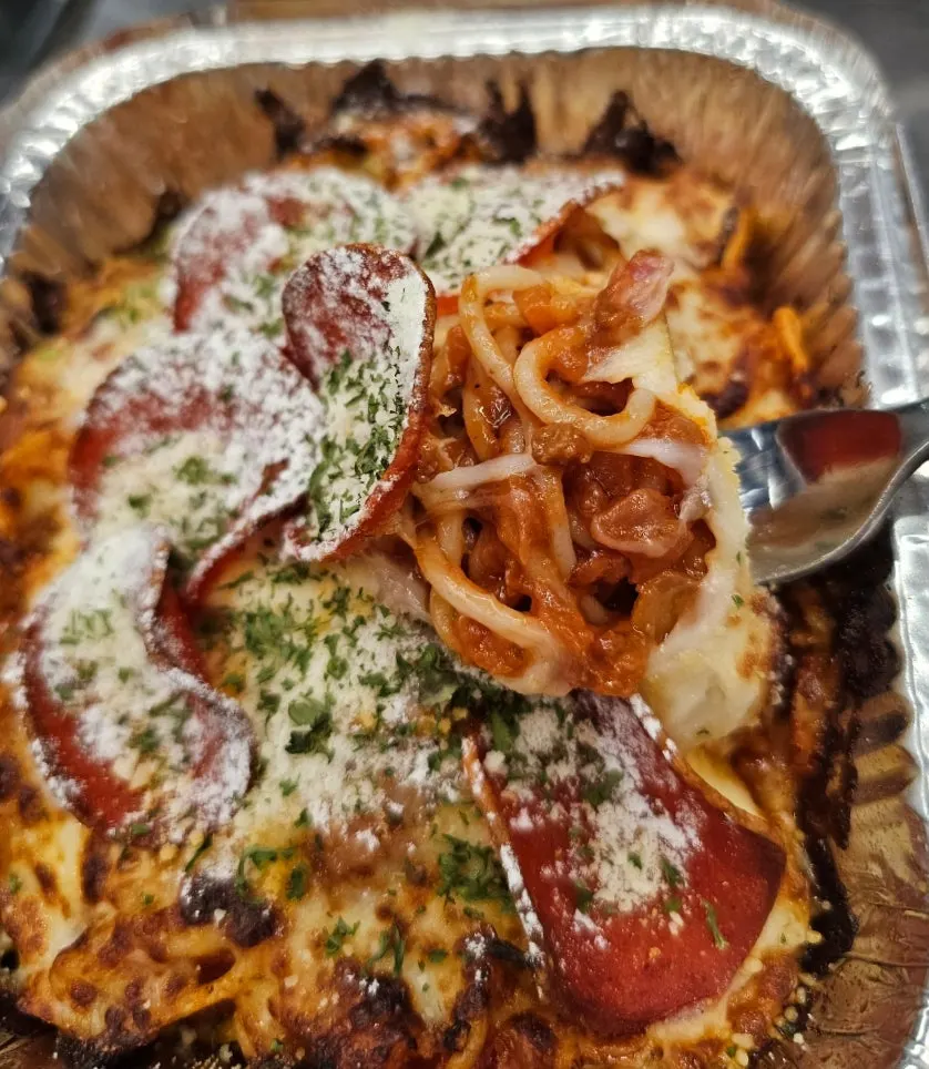 Table set with pizza, cola, and Meat Ragu Cheese Spaghetti