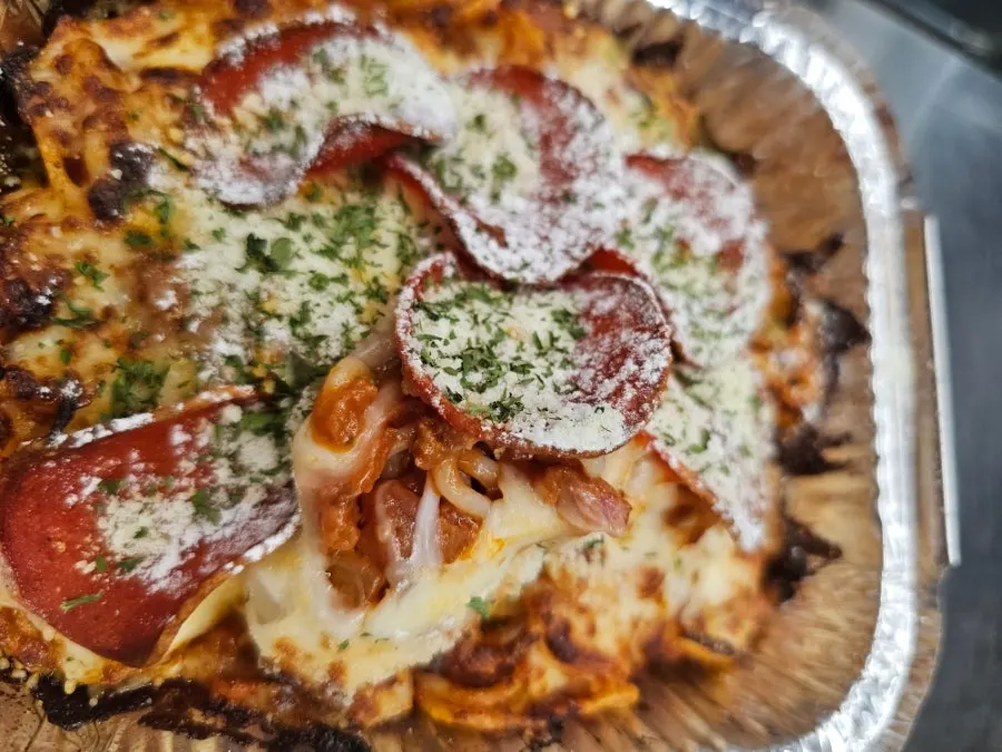 Cheese stretching from a serving of Meat Ragu Cheese Spaghetti