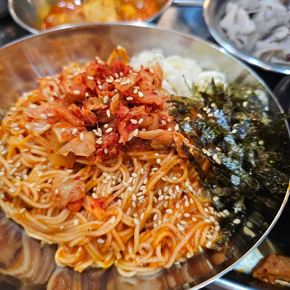 Gopchang stew with added ramen and complimentary bibim noodles