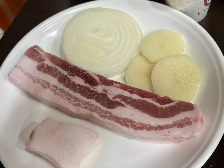 An additional order of pork belly on the cauldron-lid grill