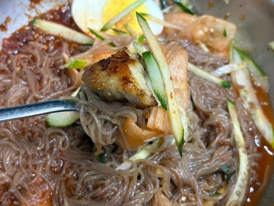 Noodles lifted up from the dessert cold noodle bowl