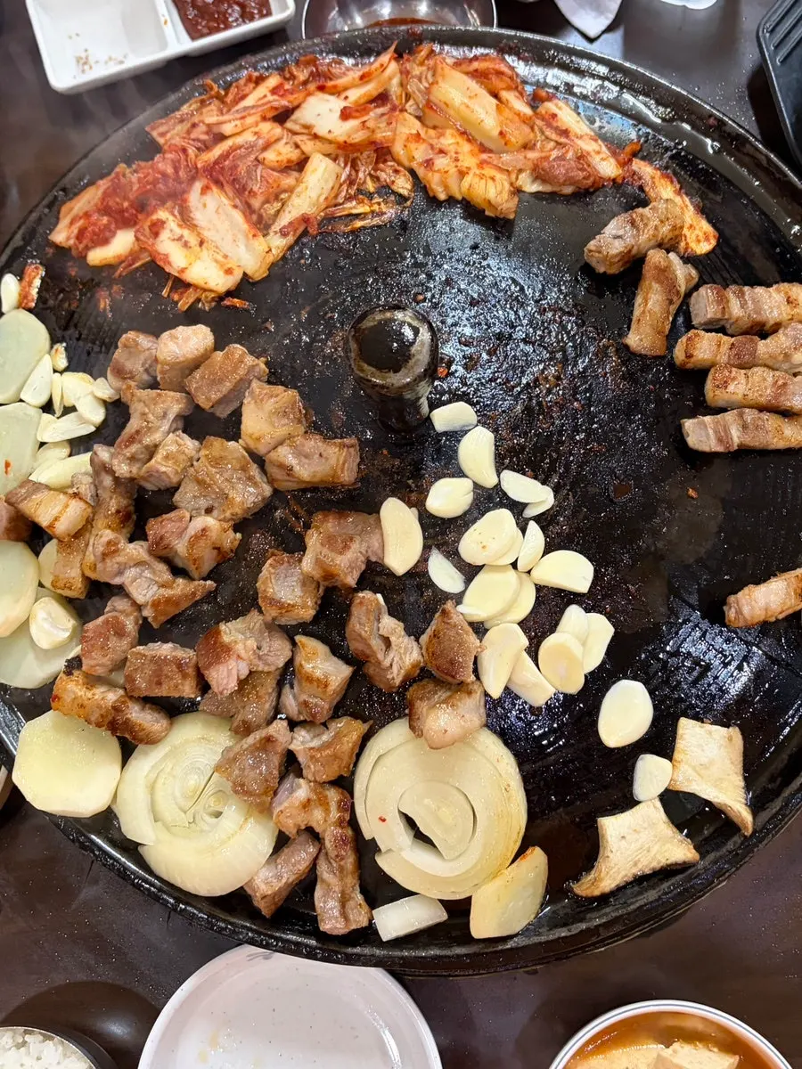 Grilled meat and onions on the grill together