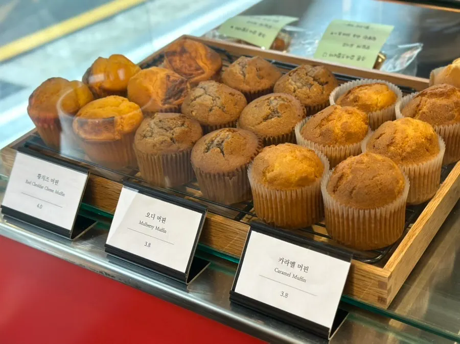Yellow cheese, mulberry, and caramel muffins on display