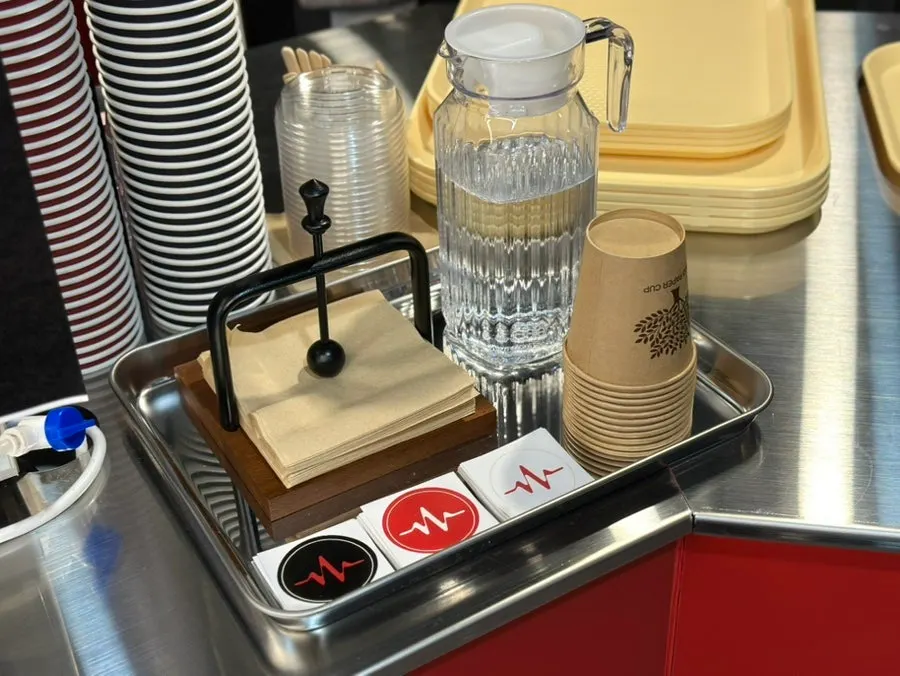 Tidy corner with napkins, water, and paper cups