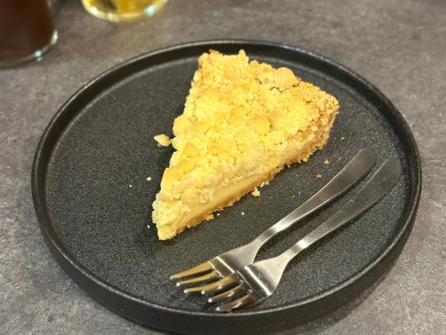 Crumble pie served on a black plate