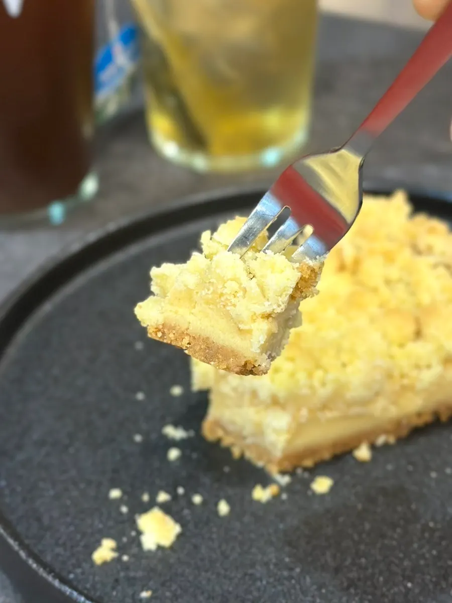 A single lifted piece of crumble pie