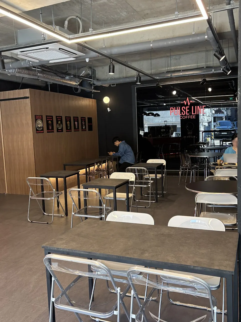Café seating with wooden walls and metal tables