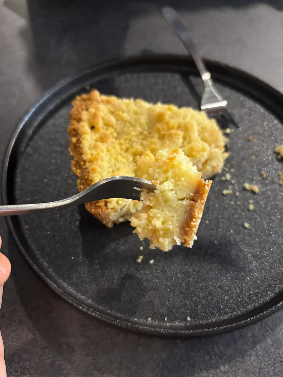A slice of crumble pie with coffee