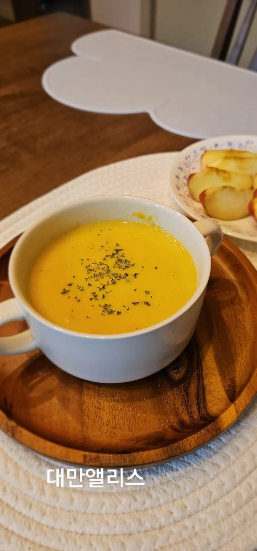 Breakfast table with pumpkin soup and bread