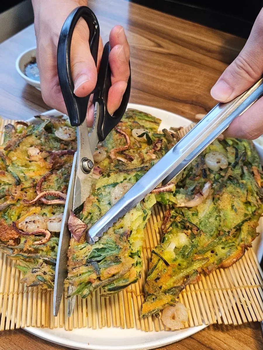 Table spread with octopus and seafood pancake