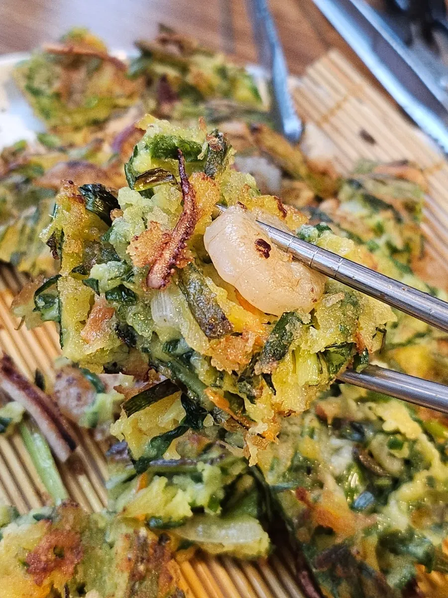 Seafood pancake being lifted after cutting