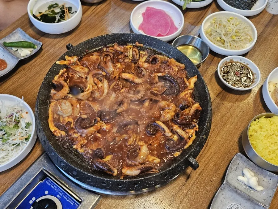 A piece of seafood pancake dipped in spicy soy sauce