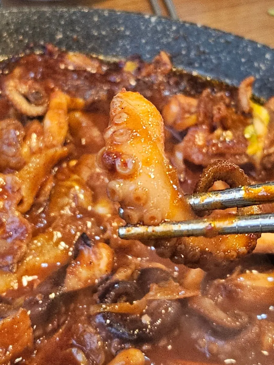 Two servings of octopus and pork belly finished on the hot plate