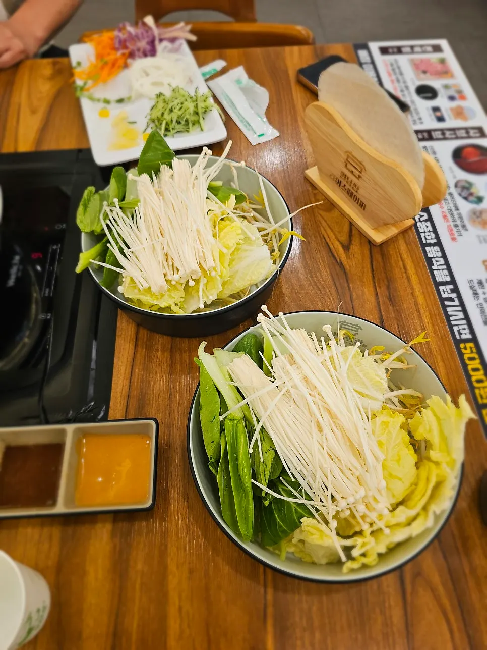 Shabu-shabu broth simmering with vegetables and mushrooms