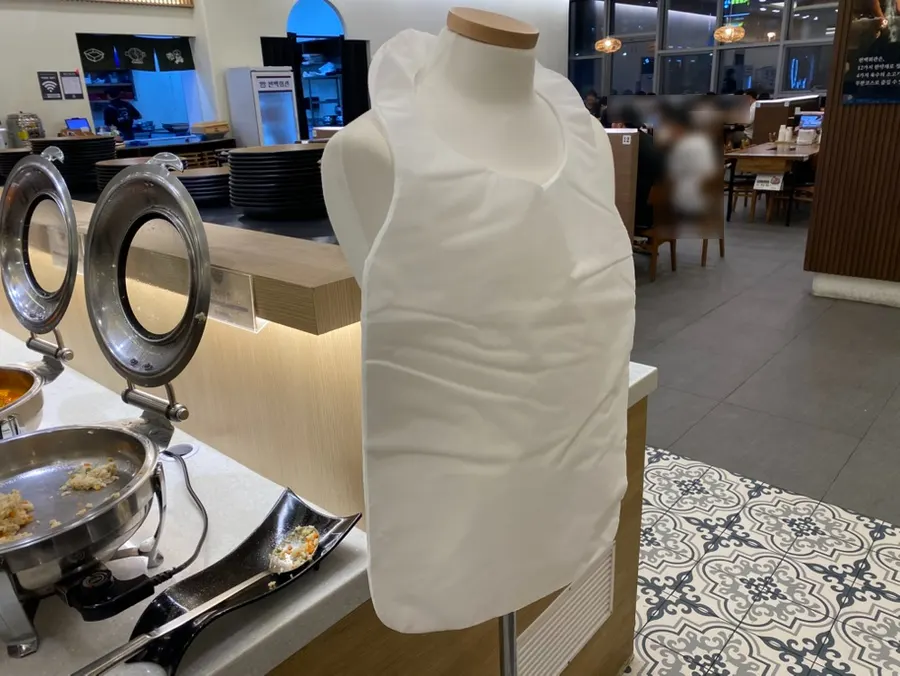 Disposable apron station next to the self-serve bar
