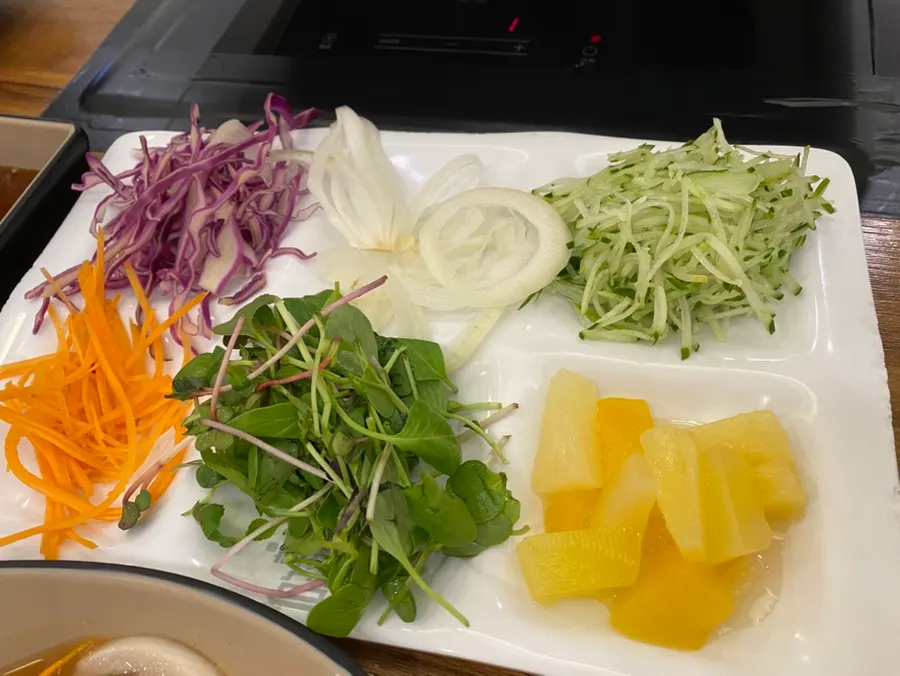 Plate of wrap vegetables and snacks gathered from the self-serve bar
