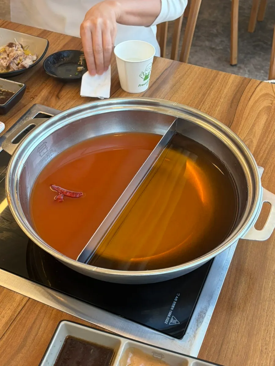 Two shabu-shabu broth pots, katsuo and spicy mushroom