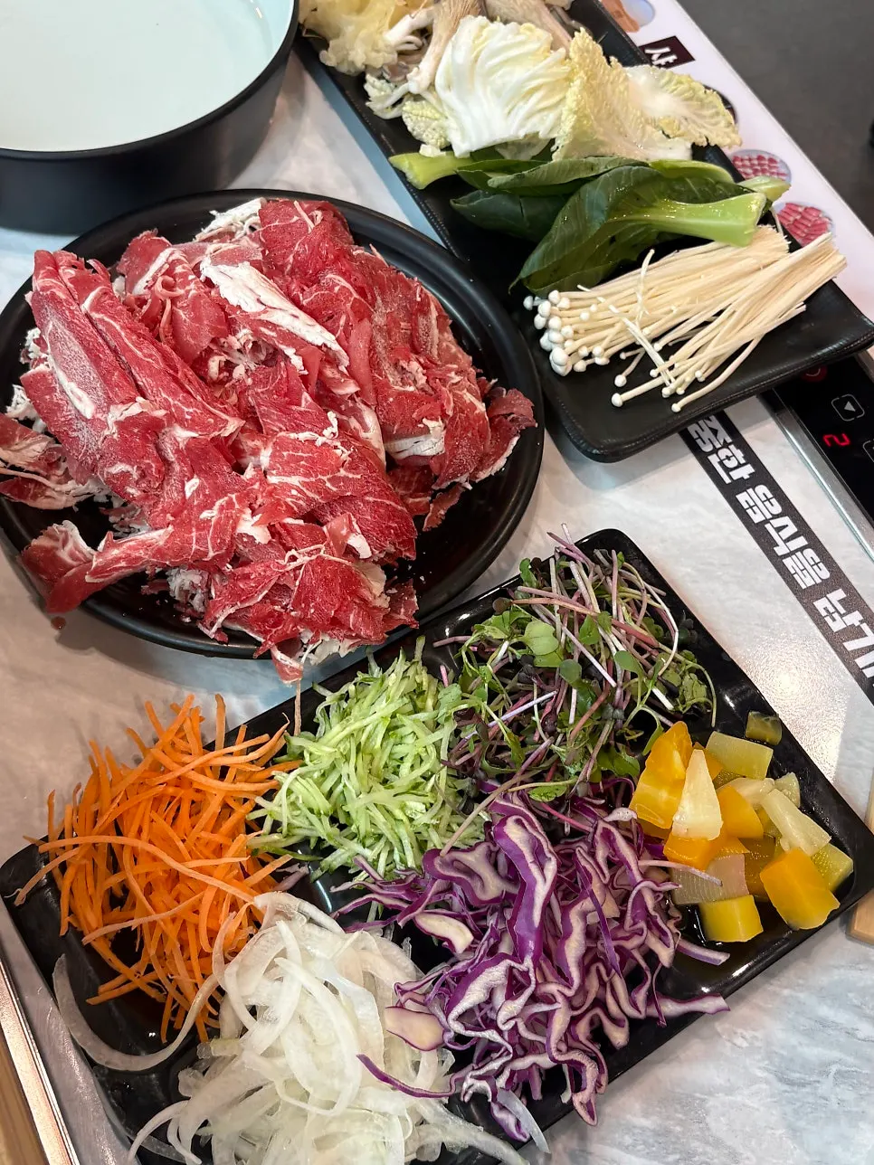 Half-and-half broth bubbling in the shabu-shabu pot