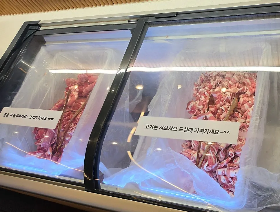 Salad bar with rice-paper roll and shabu-shabu ingredients laid out