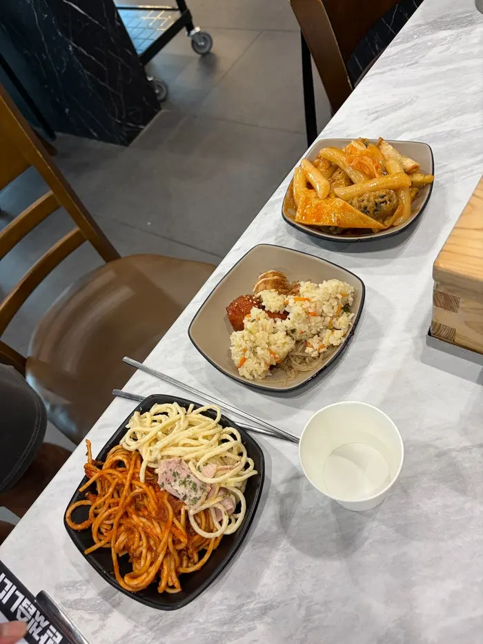 Self-serve bar with pasta, dakgangjeong, and fried items