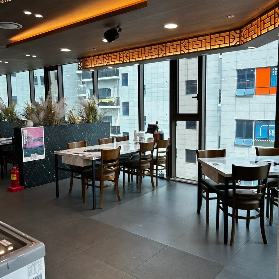 Dining hall with generous table spacing at Pyeonbaek Hoegwan Siheung Janggok Branch