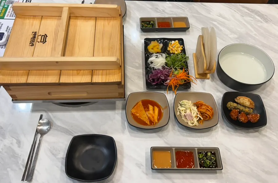 Side dishes and spring rolls set out on the table