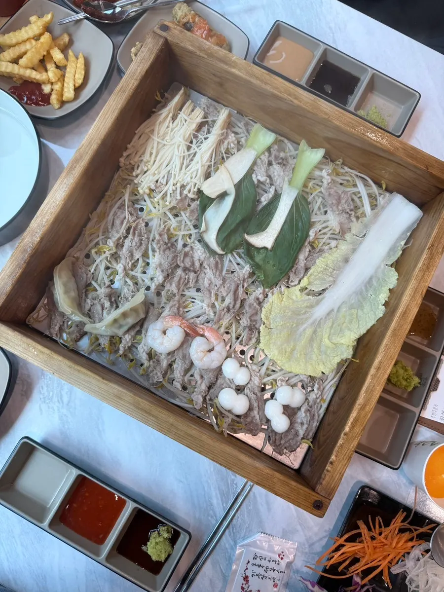 Table filled with self-serve bar vegetables and side dishes