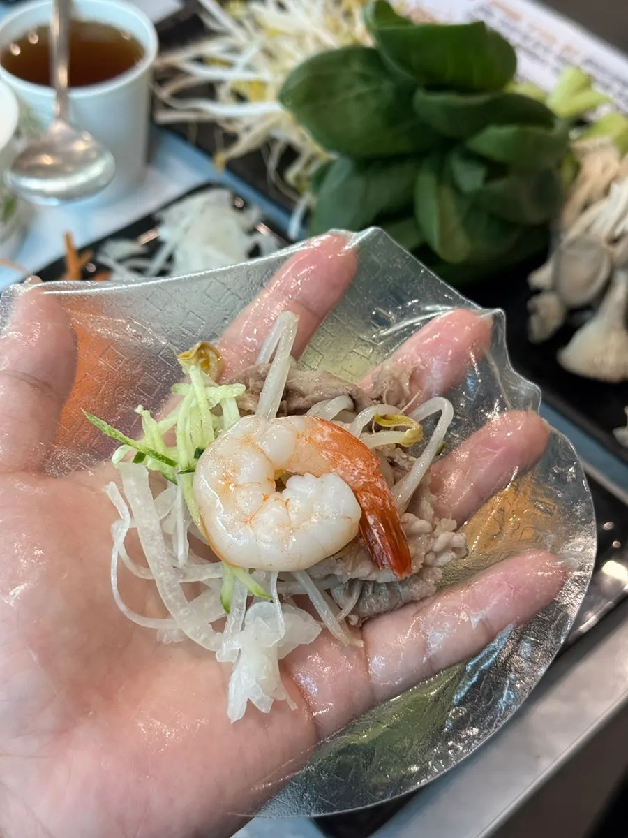 Bean sprouts, napa cabbage, and mushrooms inside the cypress steamed dish