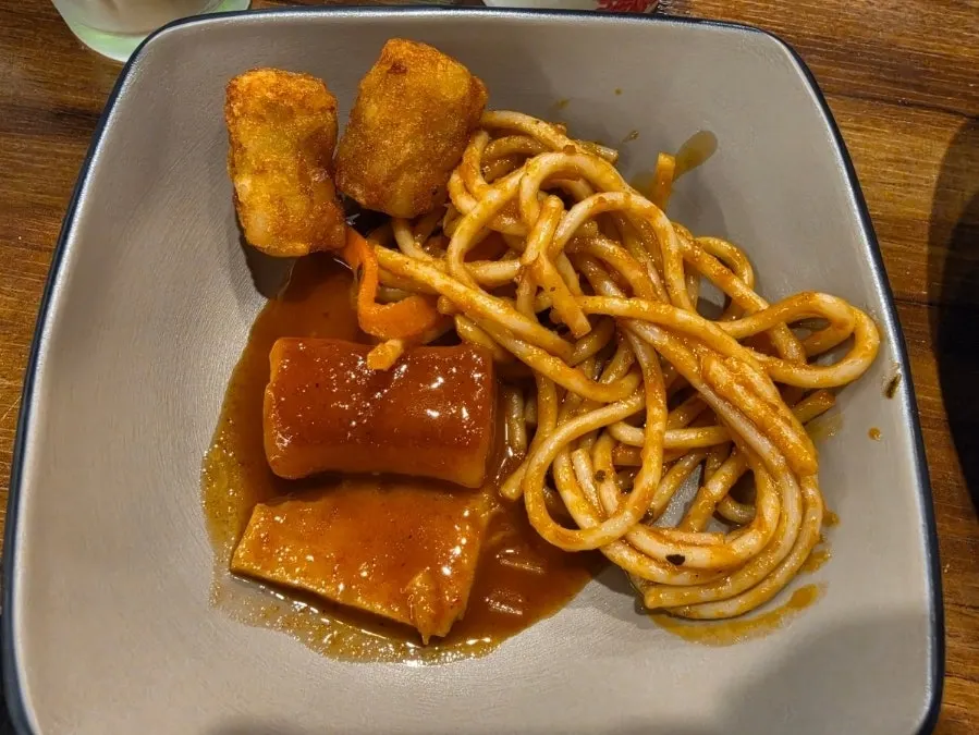Plate of tteokbokki and fries taken from the salad bar