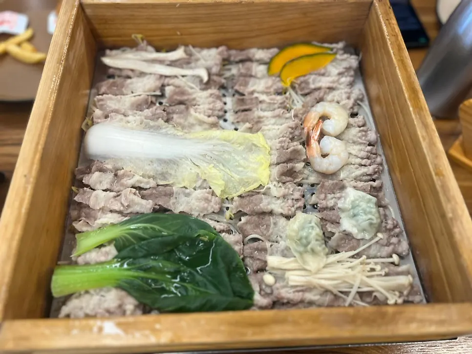 Finished cypress steam alongside rice-paper roll ingredients