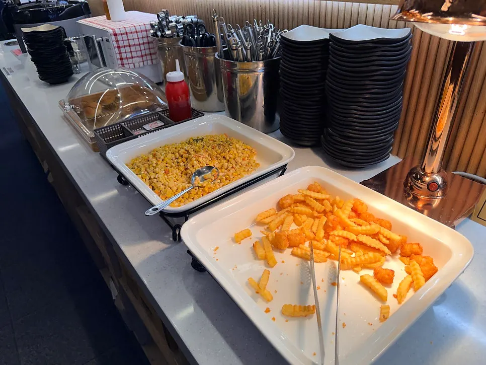 Side dishes and extras placed at the salad bar