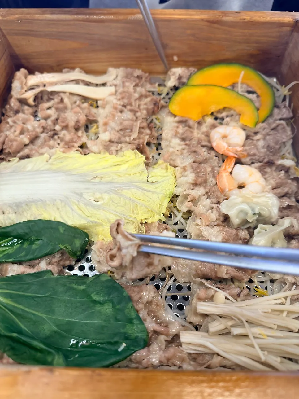 Opened lid revealing the beef brisket cypress steam