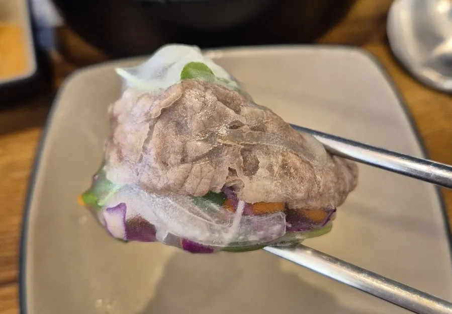Cypress steam wrapped in rice paper as a summer roll