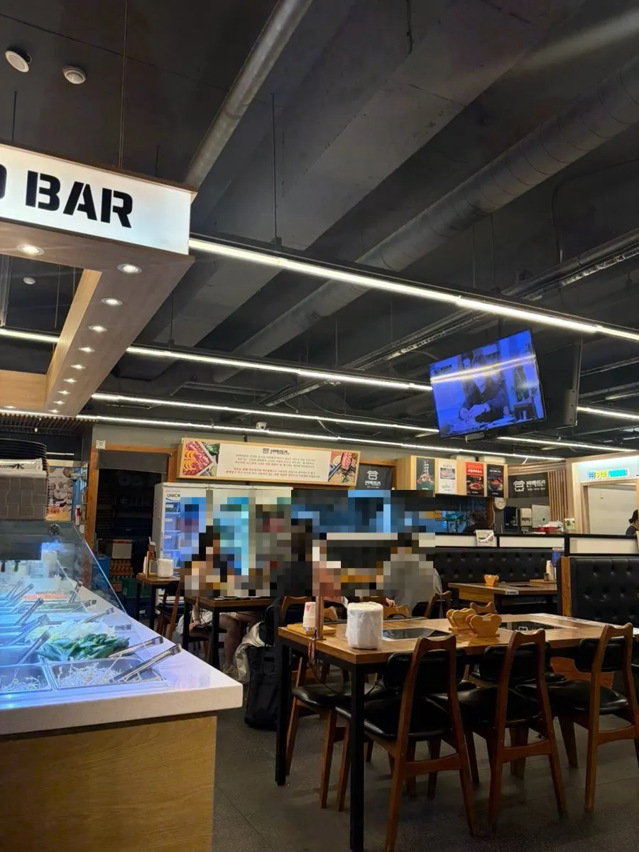 Interior seating at Pyeonbaek Hoegwan Main Branch with wide table spacing
