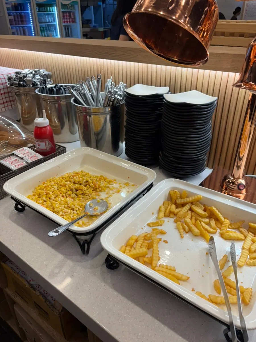 French fries and corn kernels on the salad bar