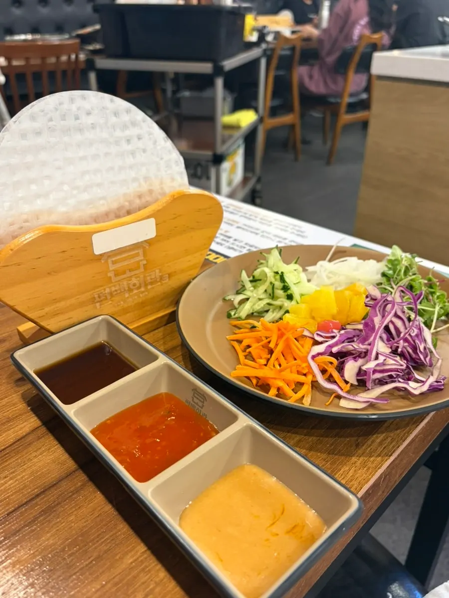 Rice-paper roll ingredients brought to the table on a plate