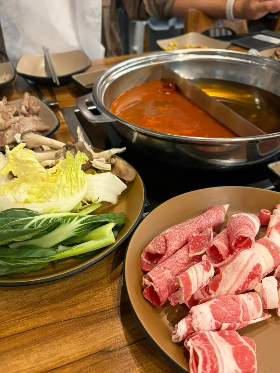 Shabu-shabu pot divided in half with two different broths